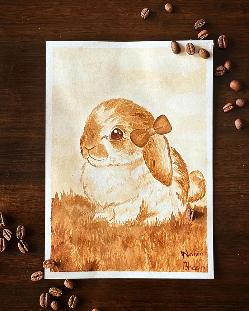 Coffee painting of a rabbit sitting in grass, titled Bunny